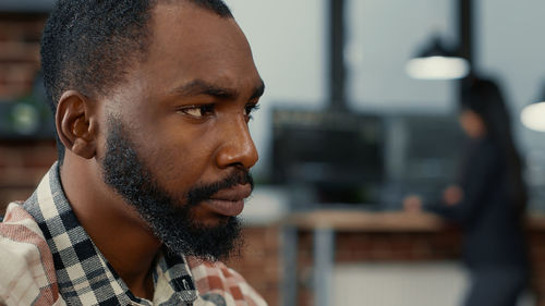 Close-up of businessman looking away at office