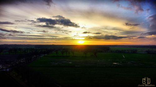 Scenic view of field against sky during sunset