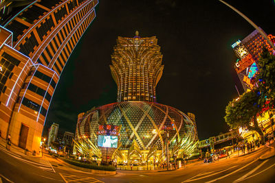 Illuminated ferris wheel in city at night