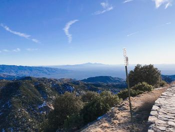 Scenic view of mountains against blue sky