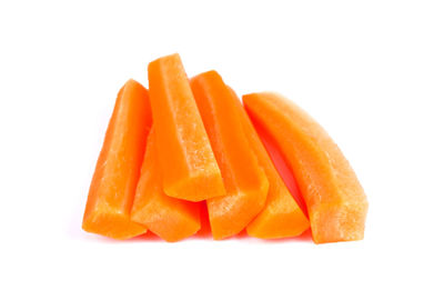 Close-up of orange slices over white background