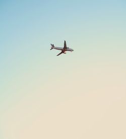 Low angle view of airplane against clear sky