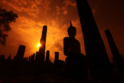 Low angle view of silhouette buddha statue