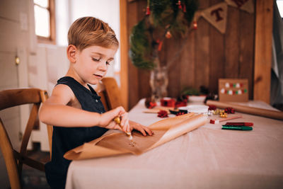 Boy playing with table at home