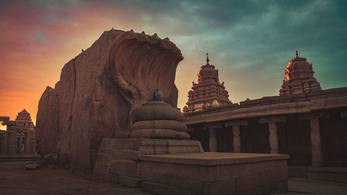 Exterior of temple against sky during sunset