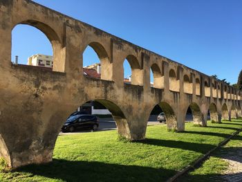 Arch bridge against clear blue sky