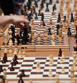Cropped hand of man playing chess on table