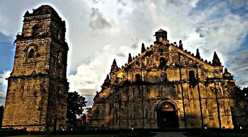 Low angle view of church against cloudy sky