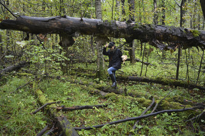 A girl collects mushrooms in the forest