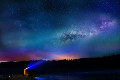 Scenic view of lake against star field at night