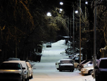 Cars in illuminated city at night