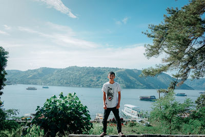 Man standing on mountain against sky