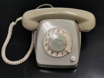 Close-up of telephone booth on table