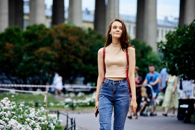 Portrait of beautiful young woman standing outdoors