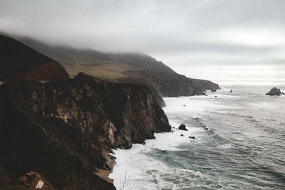 Scenic view of sea and mountains against sky