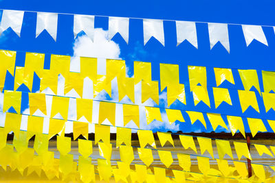 Low angle view of flags against sky