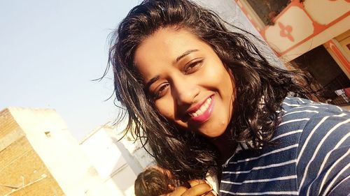 Close-up portrait of a smiling young woman