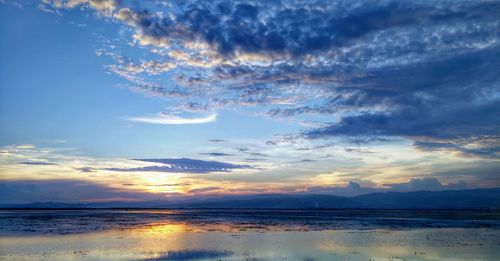 Scenic view of sea against sky at sunset