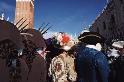 Rear view of people in front of traditional building