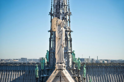 Statues of angel, chimeras on roof of notre-dame de paris. paris, france before fire april 15, 2019