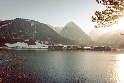 Scenic view of lake by snowcapped mountains against sky