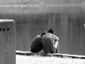 Couple sitting at lakeshore