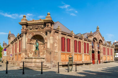 Low angle view of statues on building against sky