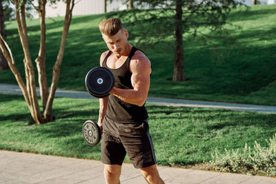 Full length of man exercising in gym