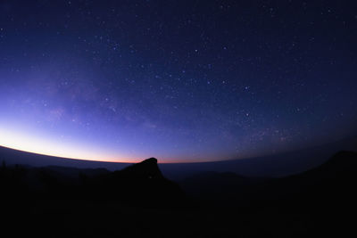 Scenic view of silhouette mountain against sky at night