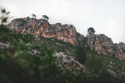 Low angle view of rock formations against sky