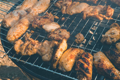 High angle view of meat on barbecue grill