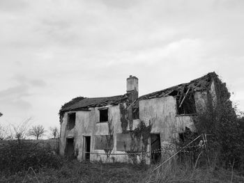 Old building on field against sky