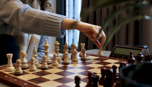 Full length of woman playing on chess board