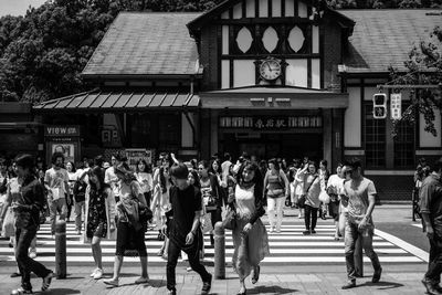 People walking on street against harajuku station