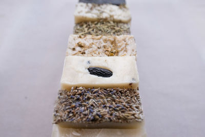 Close-up of bread in container on table against white background