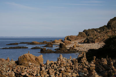 View of rocky beach against sky