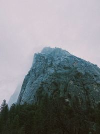 Low angle view of rock formation against sky