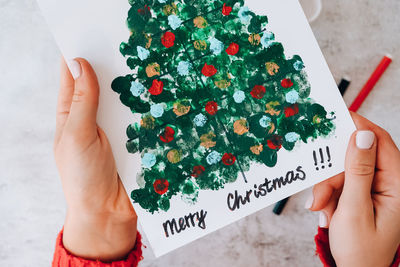 Diy making greeting card handmade crafts on holiday for children. paint with fingers merry christmas 