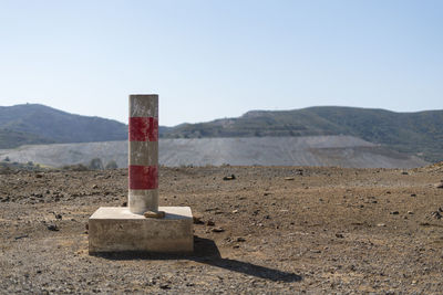 Wooden posts on mountain against sky