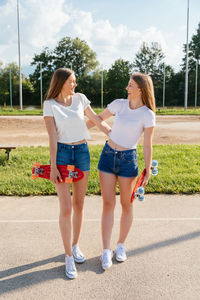 Two teenage girls having fun and holding hands