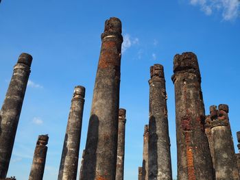 Low angle view of old ruins against blue sky