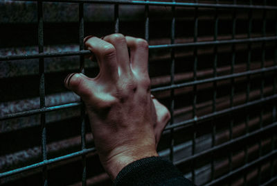 Close-up of man hand on metal