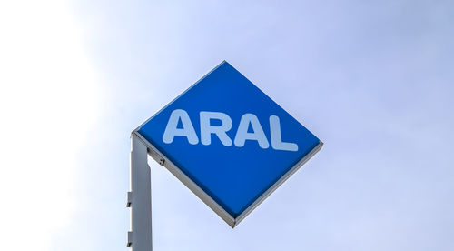 Low angle view of road sign against sky