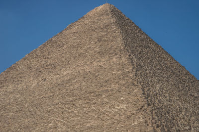 Low angle view of historical building against clear blue sky