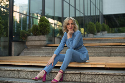 Portrait of smiling young woman sitting outdoors