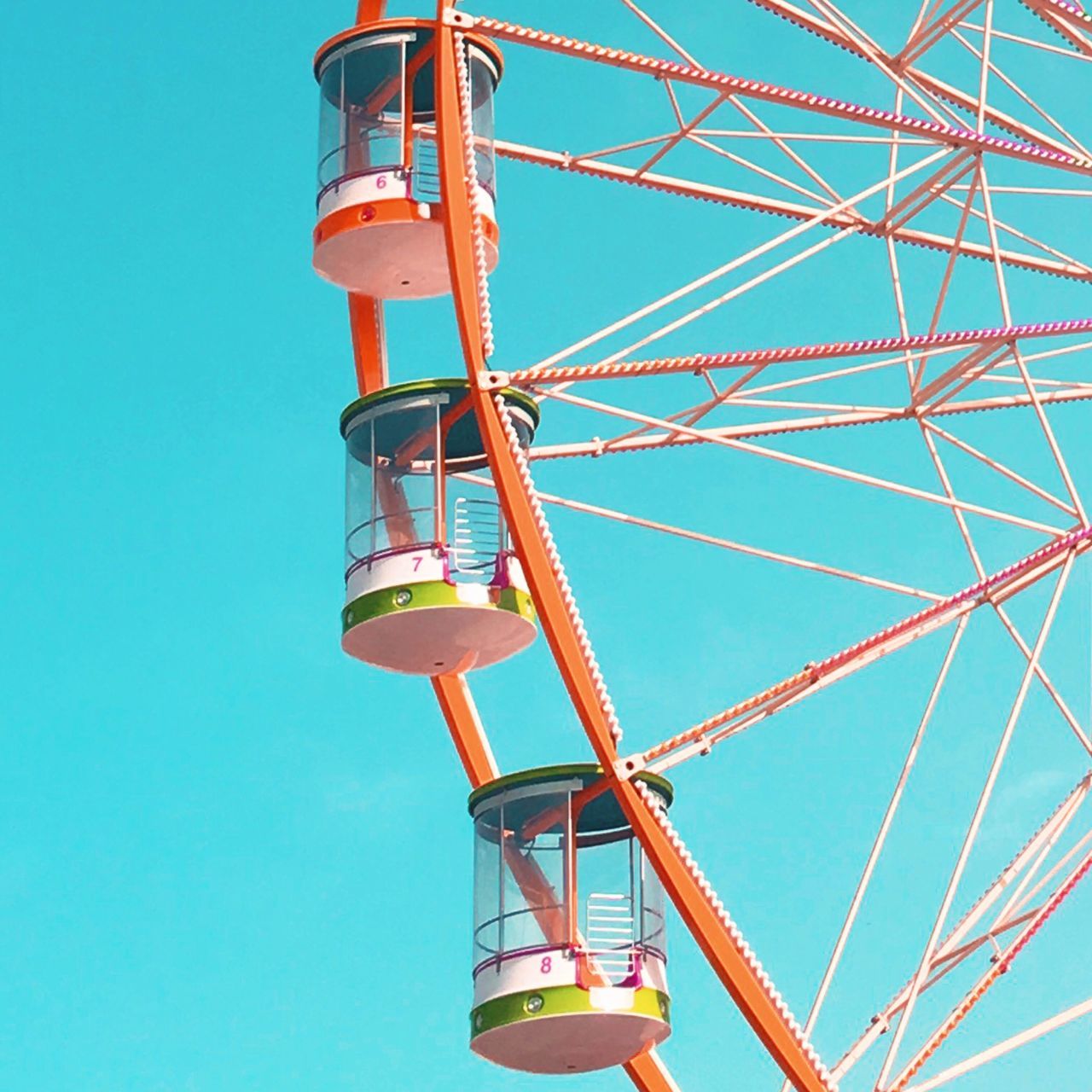 low angle view, clear sky, amusement park, arts culture and entertainment, blue, day, outdoors, amusement park ride, no people, sky, ferris wheel