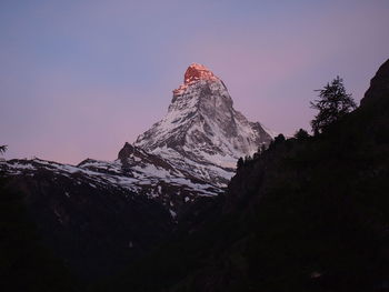 Low angle view of snowcapped mountain against sky during winter