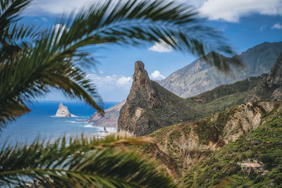 Scenic view of sea and mountains against sky