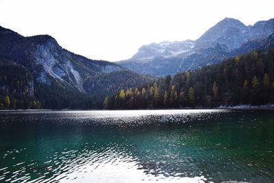 Scenic view of lake by mountains against sky