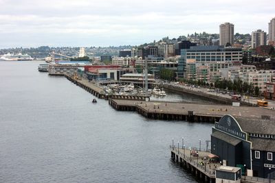 Boats in harbor with buildings in background